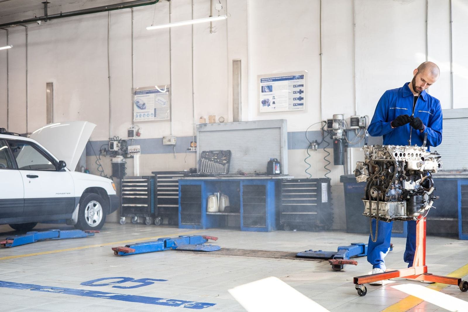 Mechanic rebuilding an engine in an auto repair shop