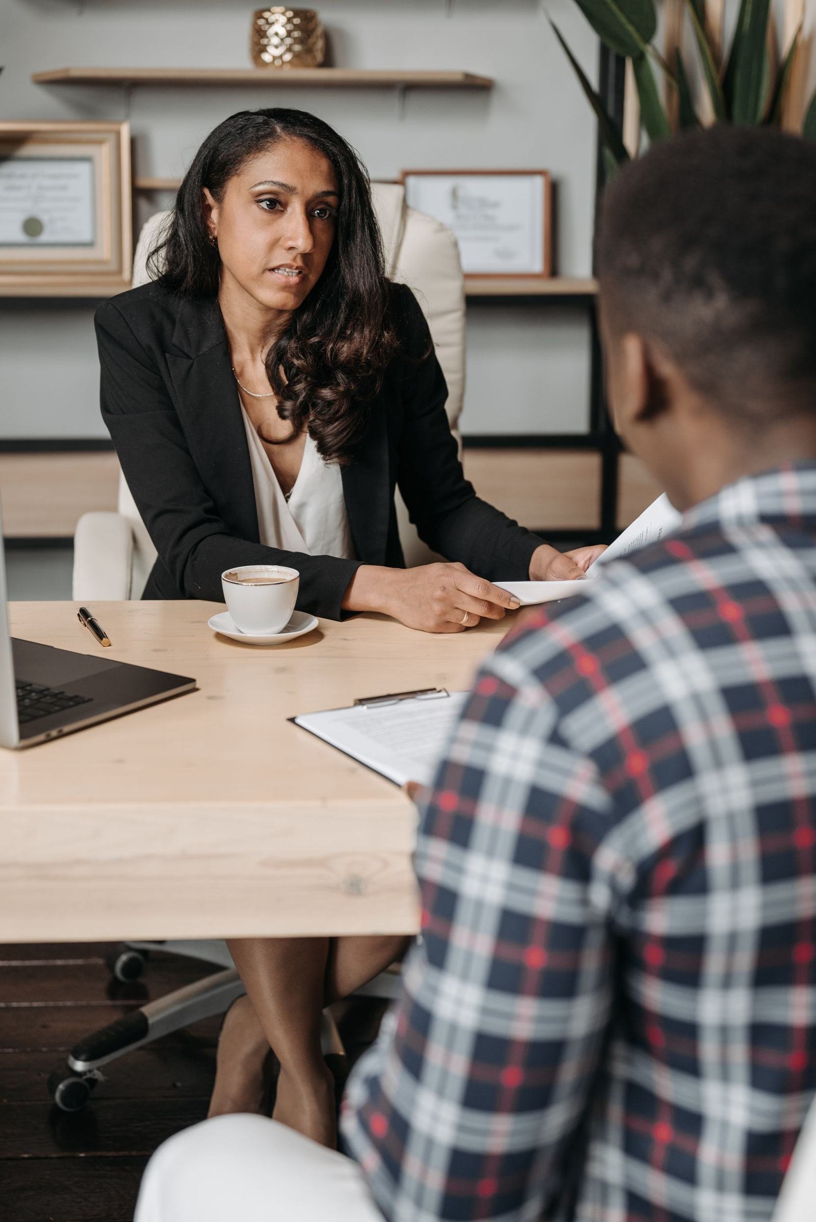 Advisor meeting with a client in her office
