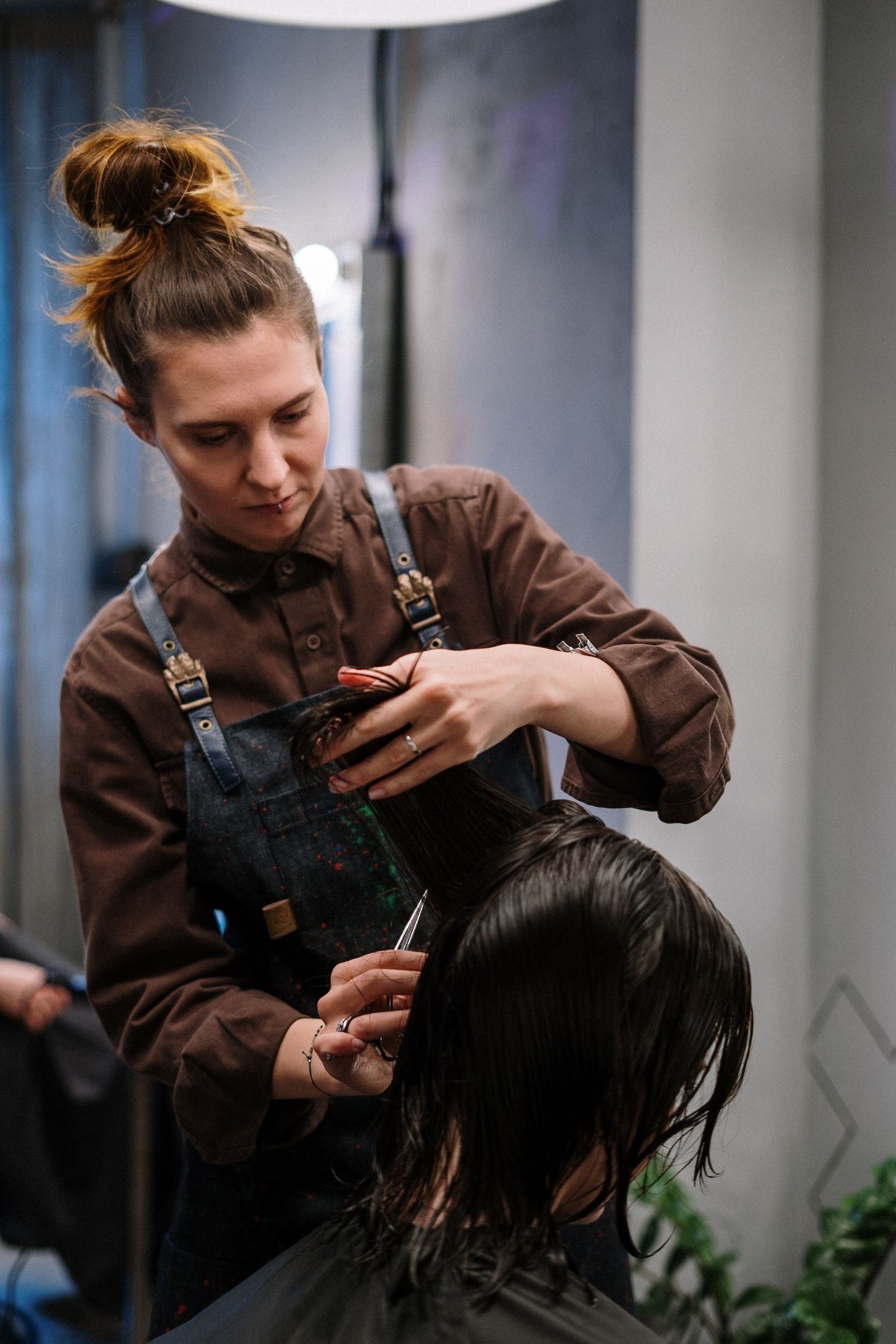 Stylist cutting a client's hair in a salon